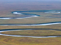 An aerial photo taken in Hulunbuir, China, on September 28, 2024, shows the winding Mogoler River passing through the grassland during autum...