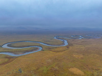 An aerial photo taken in Hulunbuir, China, on September 28, 2024, shows the winding Mogoler River passing through the grassland during autum...