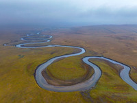 An aerial photo taken in Hulunbuir, China, on September 28, 2024, shows the winding Mogoler River passing through the grassland during autum...