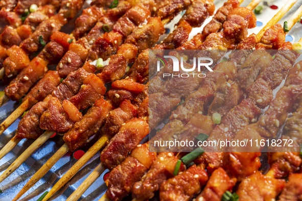 Mutton skewers are displayed at a barbecue stand at a night market in Nanning, China, on April 13, 2024. 