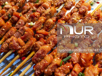 Mutton skewers are displayed at a barbecue stand at a night market in Nanning, China, on April 13, 2024. (