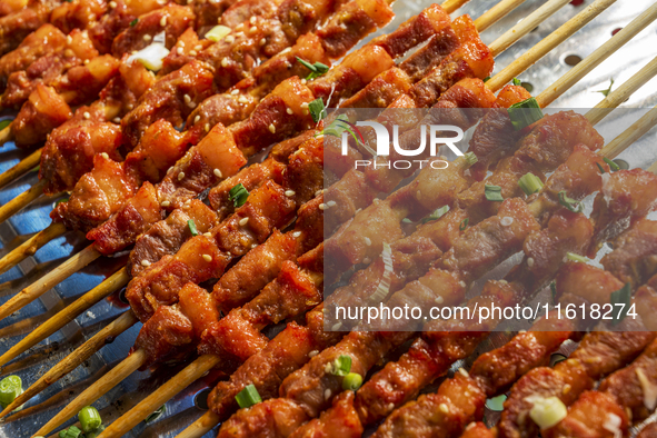 Mutton skewers are displayed at a barbecue stand at a night market in Nanning, China, on April 13, 2024. 