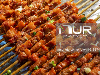 Mutton skewers are displayed at a barbecue stand at a night market in Nanning, China, on April 13, 2024. (