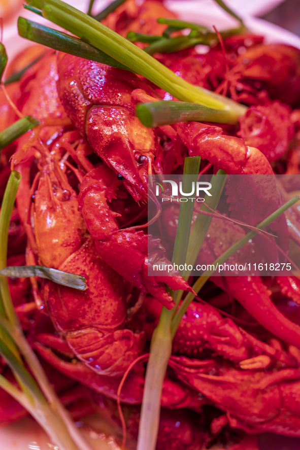 Crayfish are displayed at a barbecue stall at a night market in Nanning, China, on April 13, 2024. 