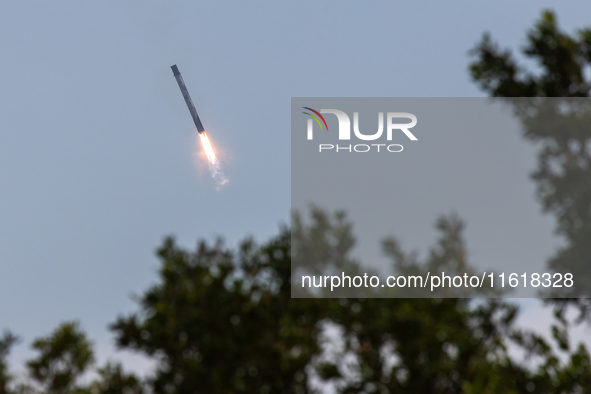 The first stage of the Falcon 9 rocket seconds before landing at complex LZ1 at the Cape Canaveral Space Station in Cape Canaveral, United S...