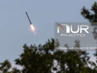 The first stage of the Falcon 9 rocket seconds before landing at complex LZ1 at the Cape Canaveral Space Station in Cape Canaveral, United S...