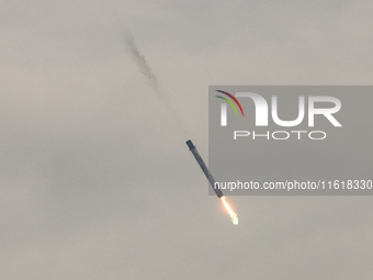 The first stage of the Falcon 9 rocket seconds before landing at complex LZ1 at the Cape Canaveral Space Station in Cape Canaveral, United S...