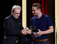 In San Sebastian, Spain, on September 28, 2024, actor Pierre Lottin receives the Silver Shell for Best Supporting Performance during the 72n...