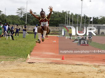 Success Udo-Gabriel of the University of Lagos, a bronze medallist in the triple jump, jumps during the final of the long jump, female categ...