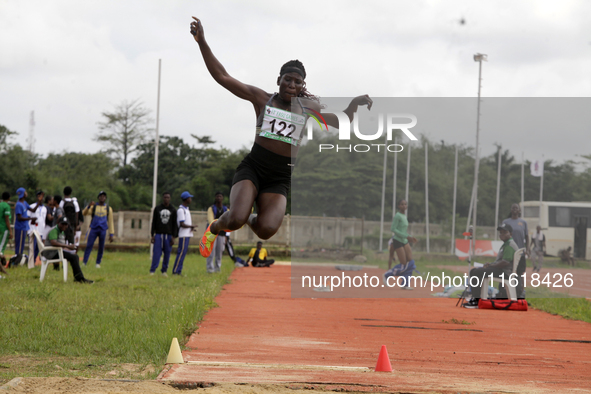 Polline Apiyo, a student from Gulu University in Uganda and a silver medallist in the triple jump female category, jumps during the final of...