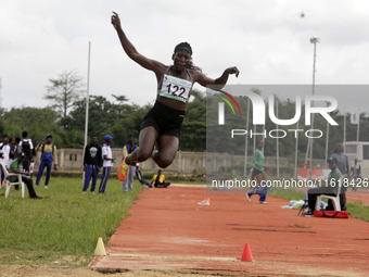 Polline Apiyo, a student from Gulu University in Uganda and a silver medallist in the triple jump female category, jumps during the final of...