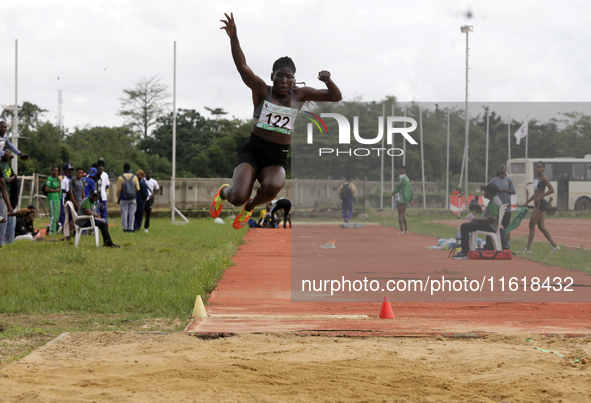 Polline Apiyo, a student from Gulu University in Uganda and a silver medallist in triple jump, competes during the long jump final in the fe...