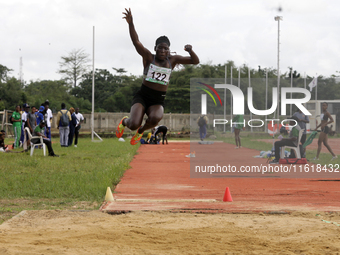 Polline Apiyo, a student from Gulu University in Uganda and a silver medallist in triple jump, competes during the long jump final in the fe...