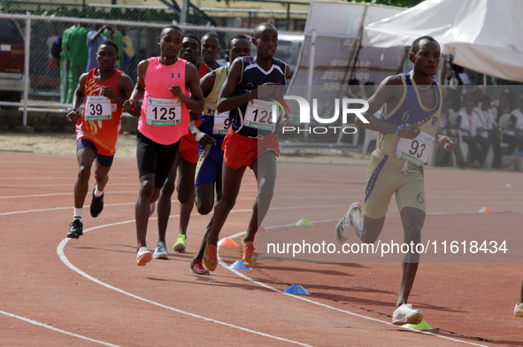 Men compete during the 5000m race final at the 11th All Africa University Games held at the University of Lagos, Akoka in Lagos, Nigeria, on...