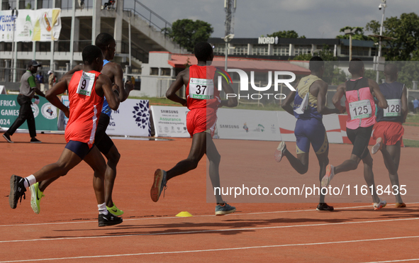 Men compete during the 5000m race final at the 11th All Africa University Games held at the University of Lagos, Akoka in Lagos, Nigeria, on...