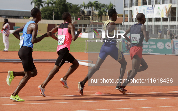 Men compete during the 5000m race final at the 11th All Africa University Games held at the University of Lagos, Akoka in Lagos, Nigeria, on...