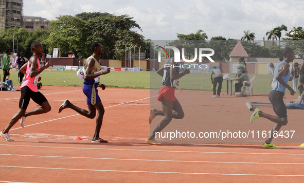 Men compete during the 5000m race final at the 11th All Africa University Games held at the University of Lagos, Akoka in Lagos, Nigeria, on...