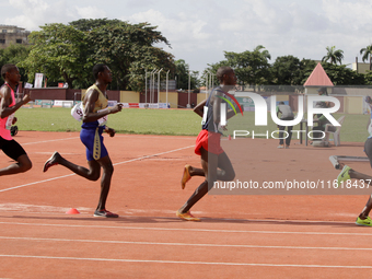 Men compete during the 5000m race final at the 11th All Africa University Games held at the University of Lagos, Akoka in Lagos, Nigeria, on...