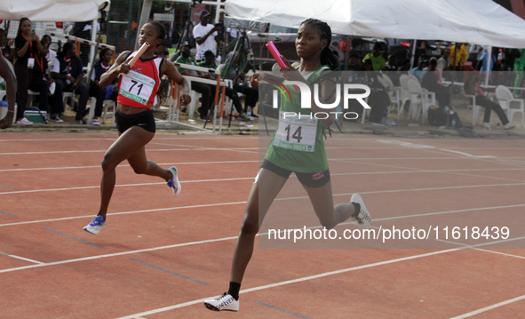 Athletes compete during the 4x400m mixed relay race final at the 11th All Africa University Games held at the University of Lagos, Akoka in...