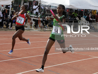 Athletes compete during the 4x400m mixed relay race final at the 11th All Africa University Games held at the University of Lagos, Akoka in...