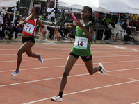 Athletes compete during the 4x400m mixed relay race final at the 11th All Africa University Games held at the University of Lagos, Akoka in...