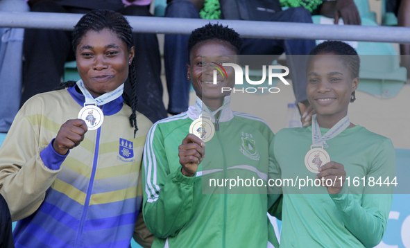 L-R: Agnes Adwoa Adjei of the University of Ghana, silver medallist in the female long jump; Adongo Celina of the University for Development...