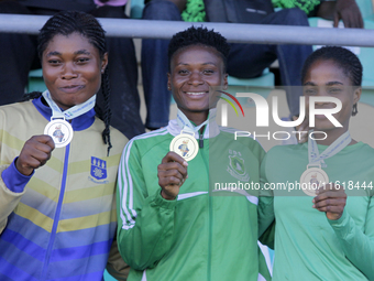 L-R: Agnes Adwoa Adjei of the University of Ghana, silver medallist in the female long jump; Adongo Celina of the University for Development...