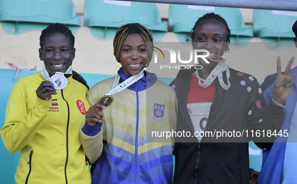 L-R: Polline Apiyo, student from Gulu University Uganda, silver medallist, triple jump in the female category; Adwoa Adjei of University of...