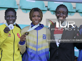 L-R: Polline Apiyo, student from Gulu University Uganda, silver medallist, triple jump in the female category; Adwoa Adjei of University of...