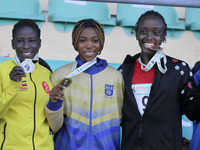 L-R: Polline Apiyo, student from Gulu University Uganda, silver medallist, triple jump in the female category; Adwoa Adjei of University of...