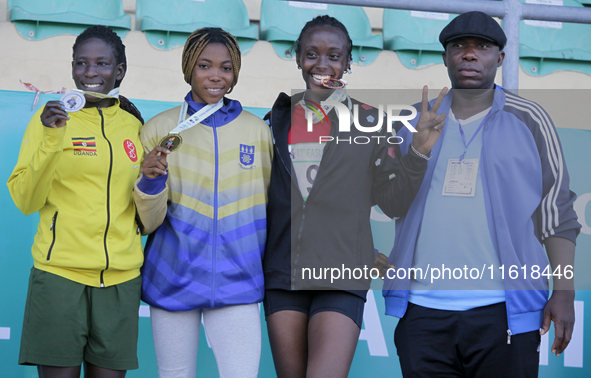 L-R: Polline Apiyo, student from Gulu University, Uganda, silver medallist, triple jump in the female category; Adwoa Adjei of the Universit...