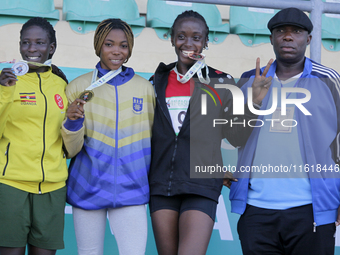 L-R: Polline Apiyo, student from Gulu University, Uganda, silver medallist, triple jump in the female category; Adwoa Adjei of the Universit...