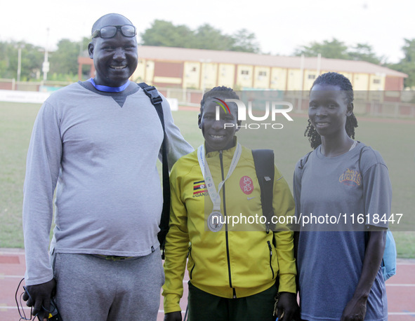 L-R: Opiyo Francis, a coach; Polline Apiyo, a student from Gulu University, Uganda, 100m runner, and silver medallist in the triple jump in...