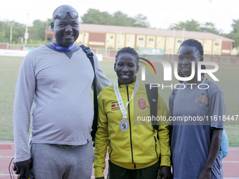 L-R: Opiyo Francis, a coach; Polline Apiyo, a student from Gulu University, Uganda, 100m runner, and silver medallist in the triple jump in...