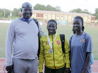 L-R: Opiyo Francis, a coach; Polline Apiyo, a student from Gulu University, Uganda, 100m runner, and silver medallist in the triple jump in...