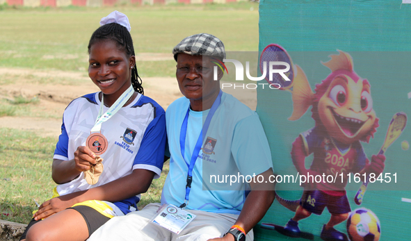 Taiwo Grace Odunewu, a student of Lagos State University and one of the 4x400m relay race silver medallists, sits with her coach, Oke Bello,...