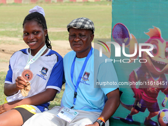 Taiwo Grace Odunewu, a student of Lagos State University and one of the 4x400m relay race silver medallists, sits with her coach, Oke Bello,...