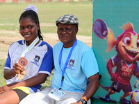 Taiwo Grace Odunewu, a student of Lagos State University and one of the 4x400m relay race silver medallists, sits with her coach, Oke Bello,...