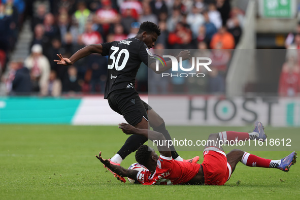 Emmanuel Latte Lath of Middlesbrough battles for possession with Stoke City's Sol Sidibe during the Sky Bet Championship match between Middl...