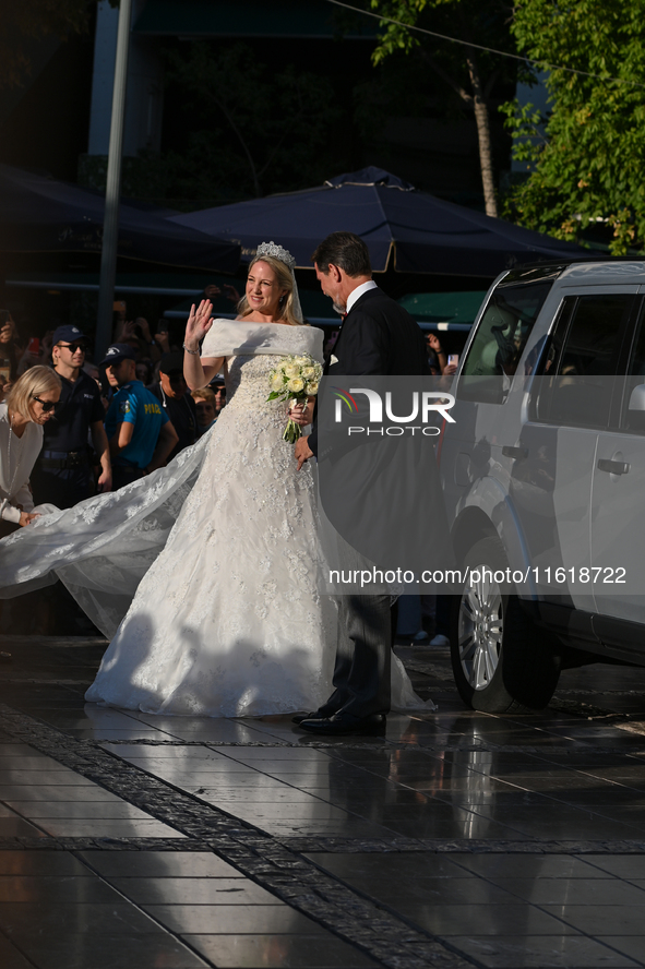 Princess Theodora of Greece, escorted by Crown Prince Pavlos of Greece, arrives at the Metropolitan Cathedral of Athens for her wedding with...