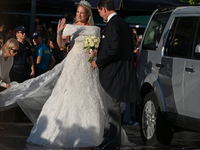 Princess Theodora of Greece, escorted by Crown Prince Pavlos of Greece, arrives at the Metropolitan Cathedral of Athens for her wedding with...