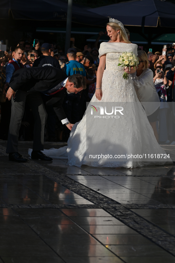 Princess Theodora of Greece, escorted by Crown Prince Pavlos of Greece, arrives at the Metropolitan Cathedral of Athens for her wedding with...