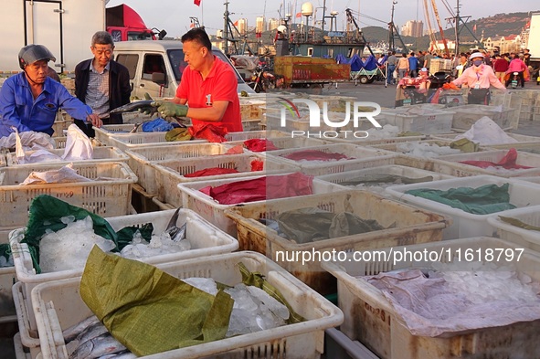 Seafood lifted ashore fills the dock at Jimiya Fishing Port in the West Coast New area of Qingdao, Shandong province, China, on September 28...