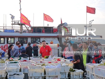 Seafood lifted ashore fills the dock at Jimiya Fishing Port in the West Coast New area of Qingdao, Shandong province, China, on September 28...