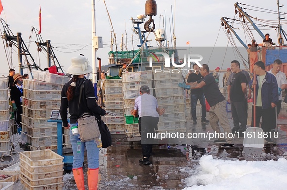 Seafood lifted ashore fills the dock at Jimiya Fishing Port in the West Coast New area of Qingdao, Shandong province, China, on September 28...