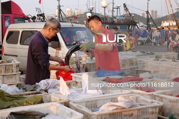 Seafood lifted ashore fills the dock at Jimiya Fishing Port in the West Coast New area of Qingdao, Shandong province, China, on September 28...