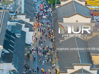 Tourists visit the Confucius Temple scenic spot in Nanjing, China, on September 28, 2024. (