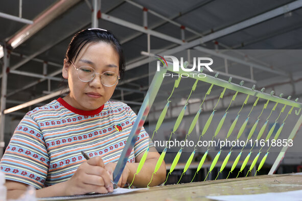 A worker works in a workshop of a fishing tackle company in Binzhou, China, on September 29, 2024. 