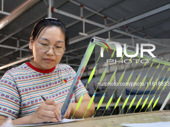 A worker works in a workshop of a fishing tackle company in Binzhou, China, on September 29, 2024. (