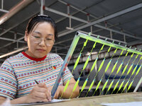 A worker works in a workshop of a fishing tackle company in Binzhou, China, on September 29, 2024. (